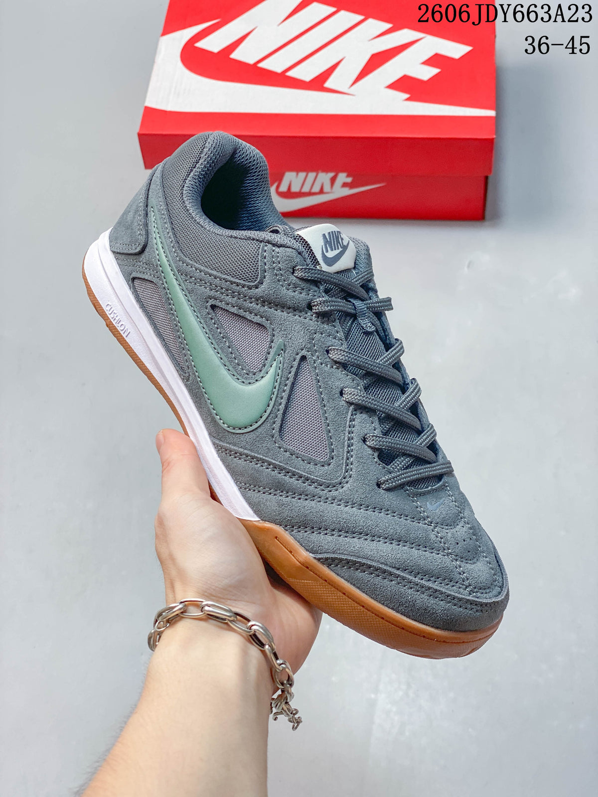 Close-up of a gray Nike Gato sneaker with pale green side accent and gum-colored sole