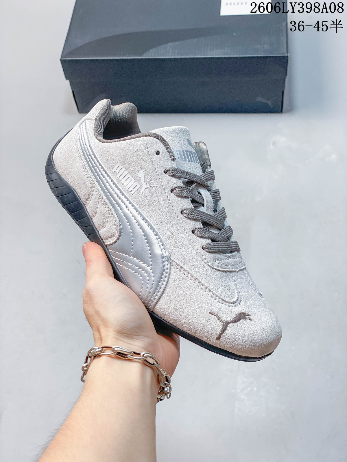Close-up of a light gray PUMA Speedcat OG sneaker with pale side stripe