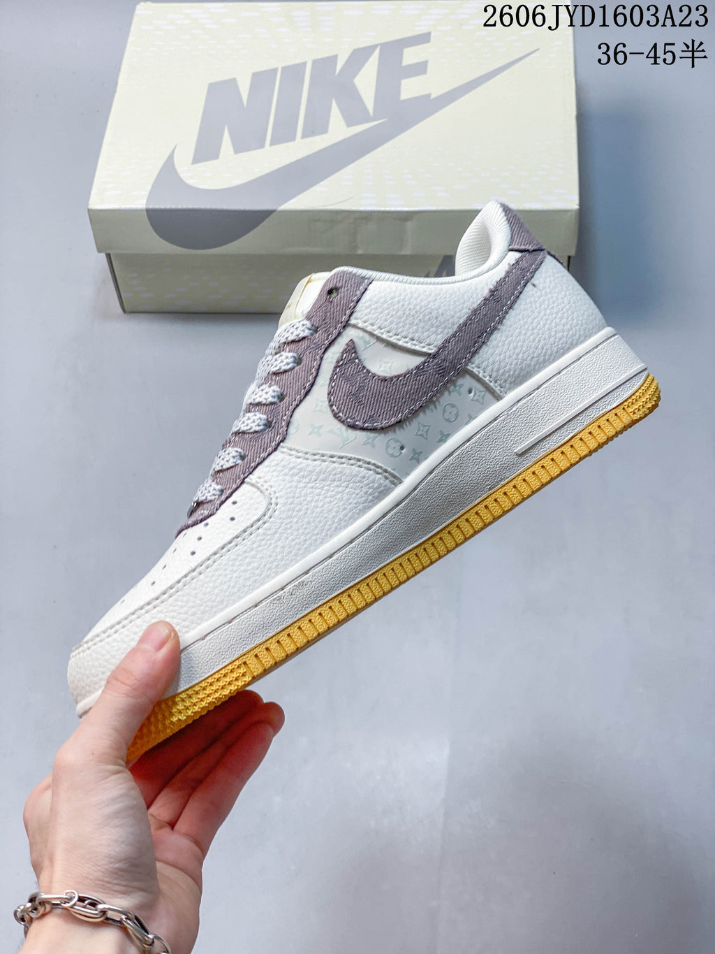 Side view of the cream and mauve low-top sneaker
