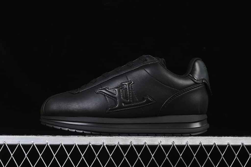 Black low-top sneaker shown from the side