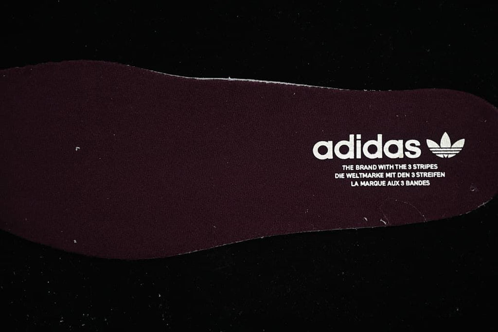 Dark burgundy shoe insert with adidas branding