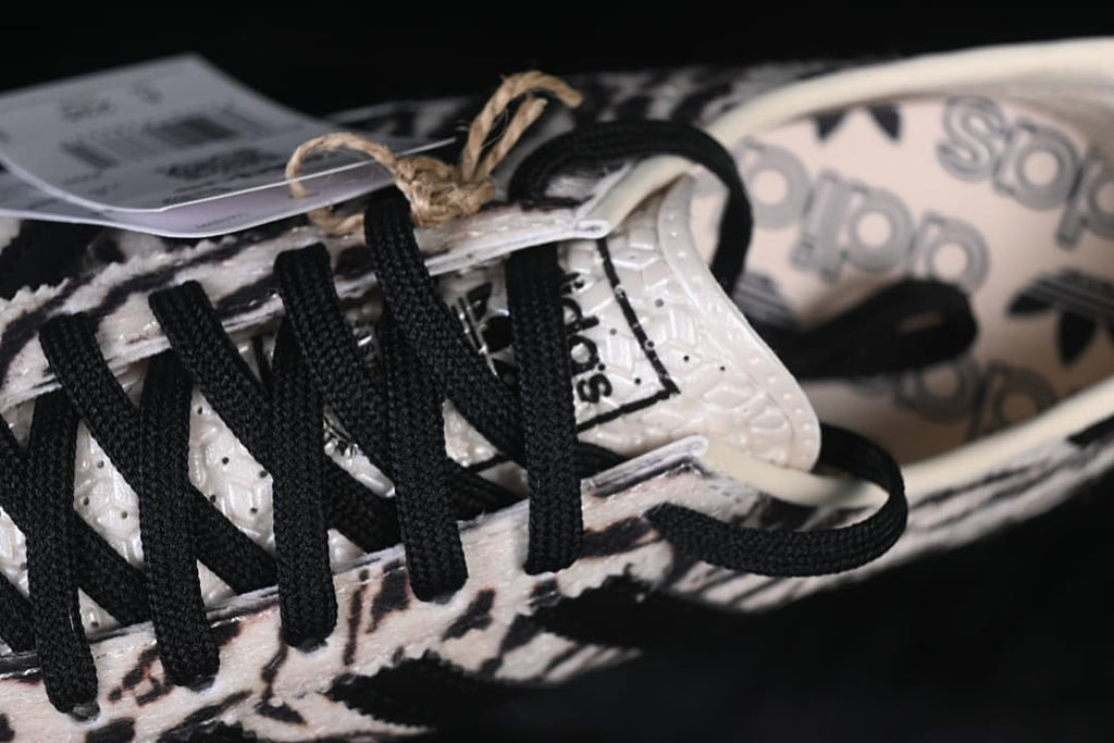 Close-up of black laces and tongue on the animal-print sneaker.