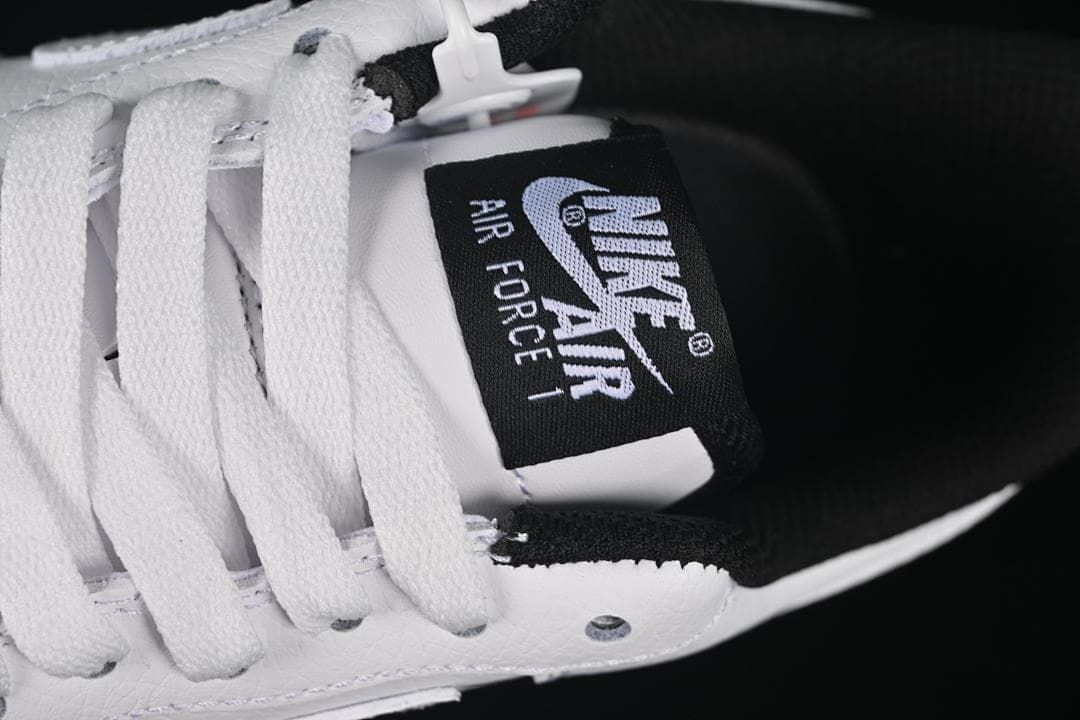 Close-up of the tongue label, white laces, and black padded collar