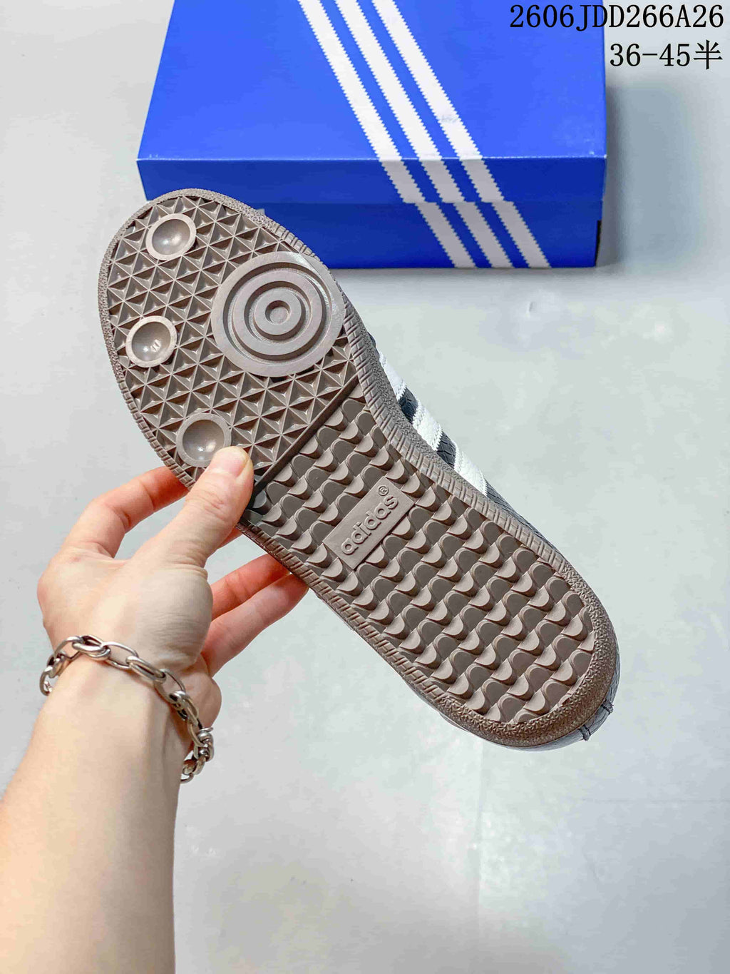 Close-up of the textured gum-tone outsole on an Adidas Samba sneaker.