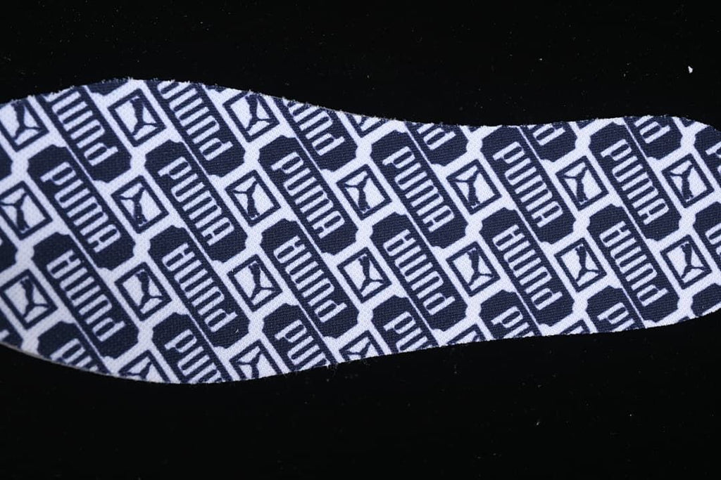Close-up of a repeating Puma-patterned shoe lining.