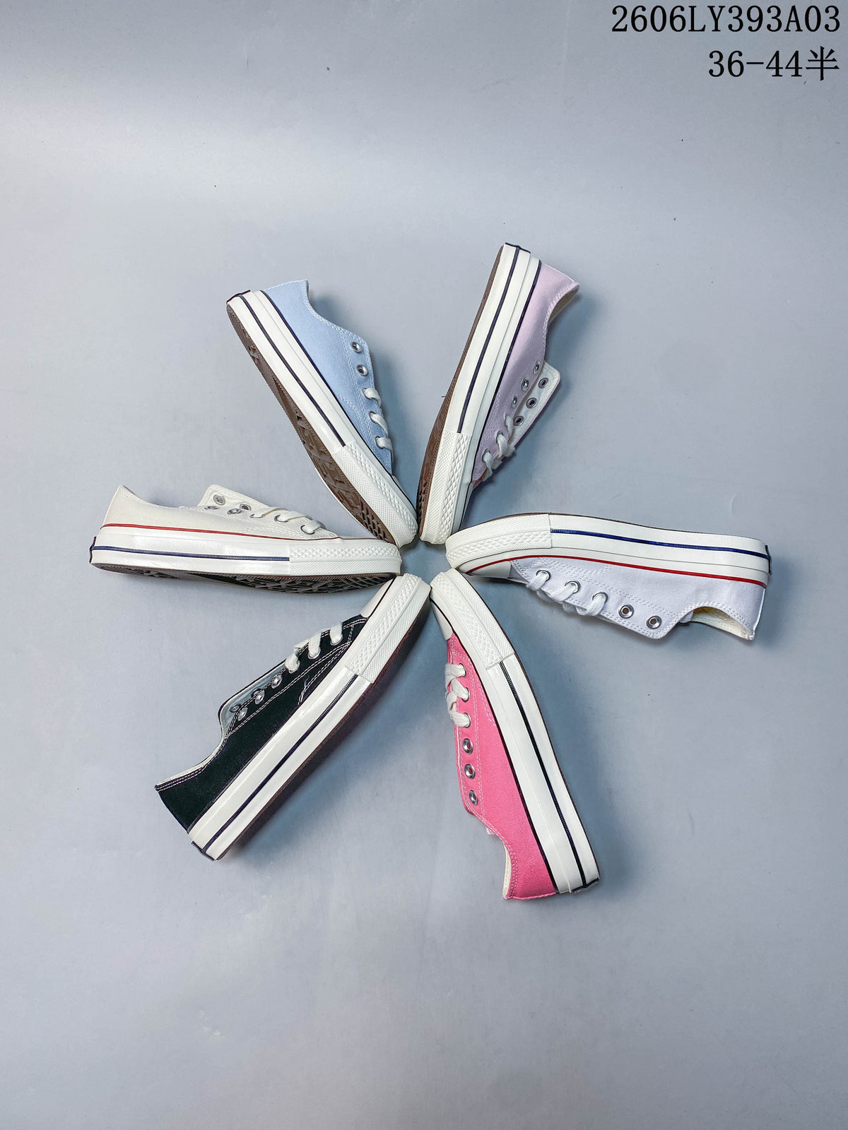Several low-top sneakers arranged in a circle in assorted colors
