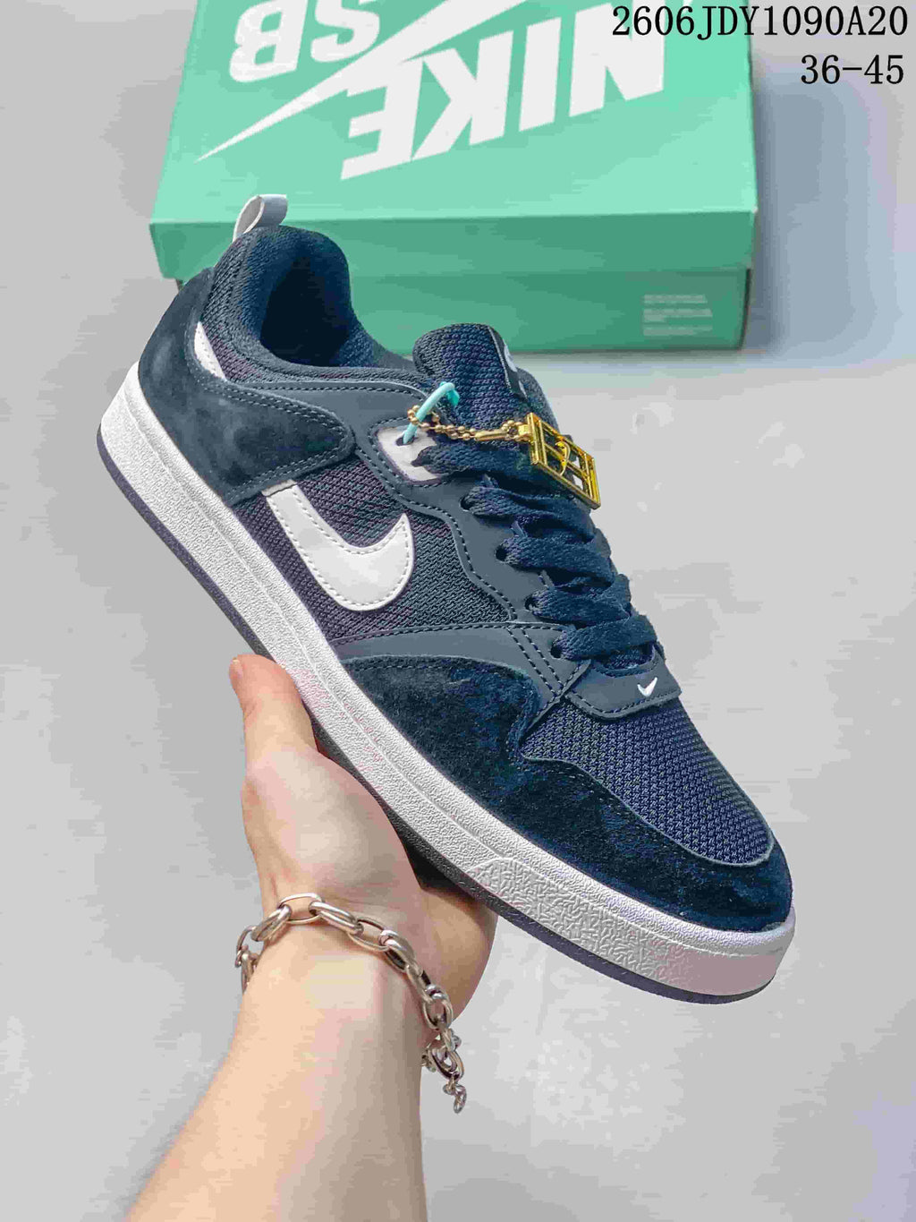 Angled side view of a navy Nike SB Alleyoop shoe with white Swoosh detailing