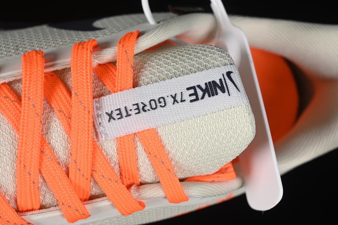 Close-up of orange laces and tongue label with Nike and GORE-TEX text