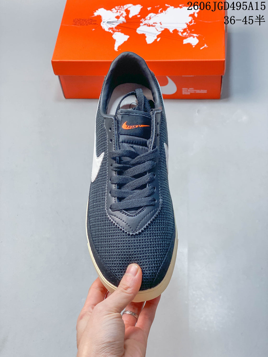 Front view of a dark navy Nike Astro Grabber sneaker with lace-up fastening and textured upper.