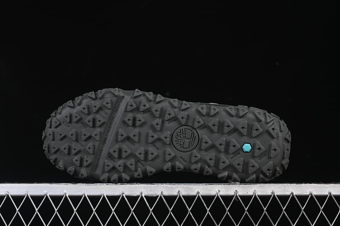 Underside view showing the deeply patterned black outsole.
