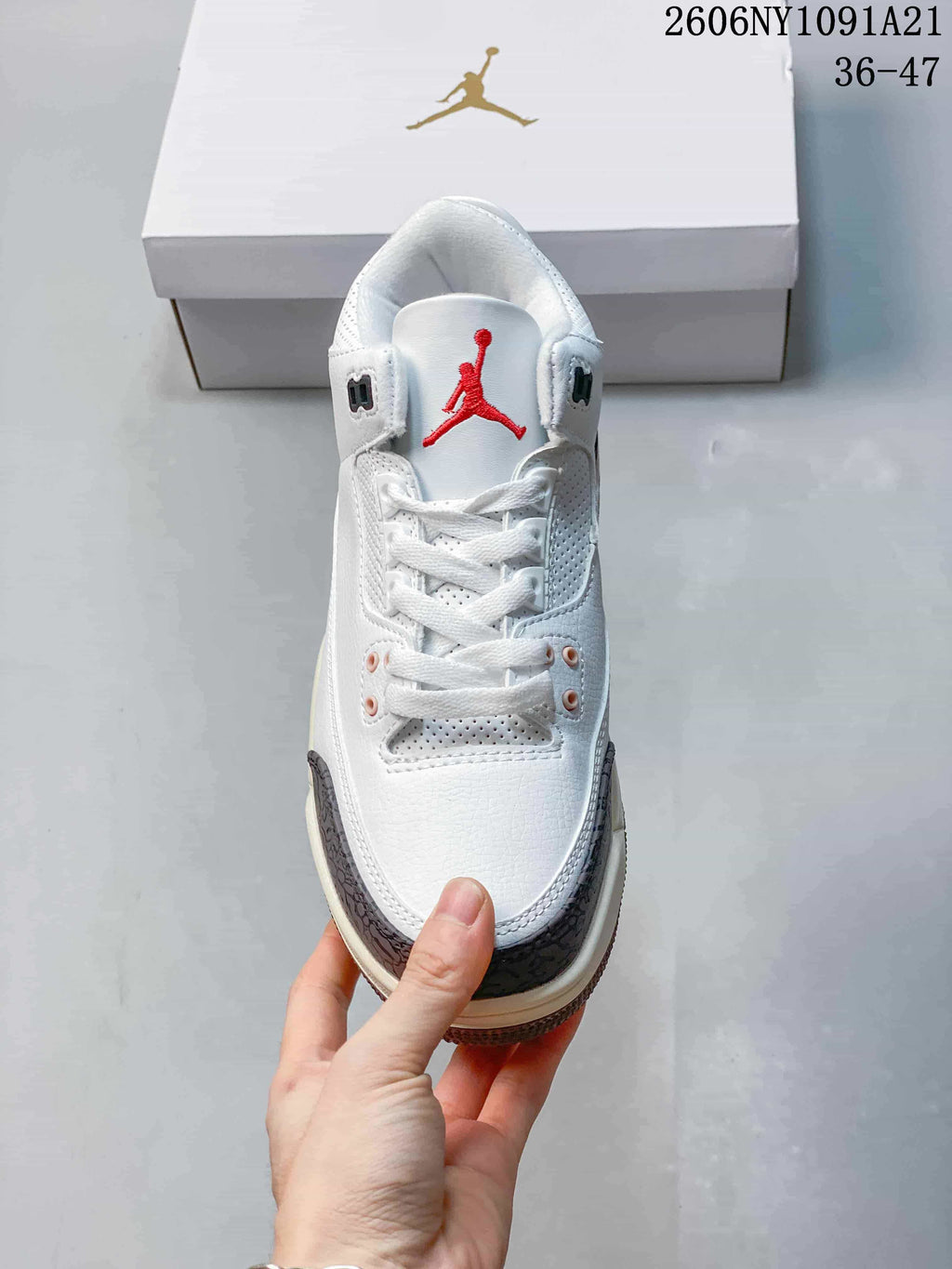 Front view showing the laces, perforated panels, and red tongue logo
