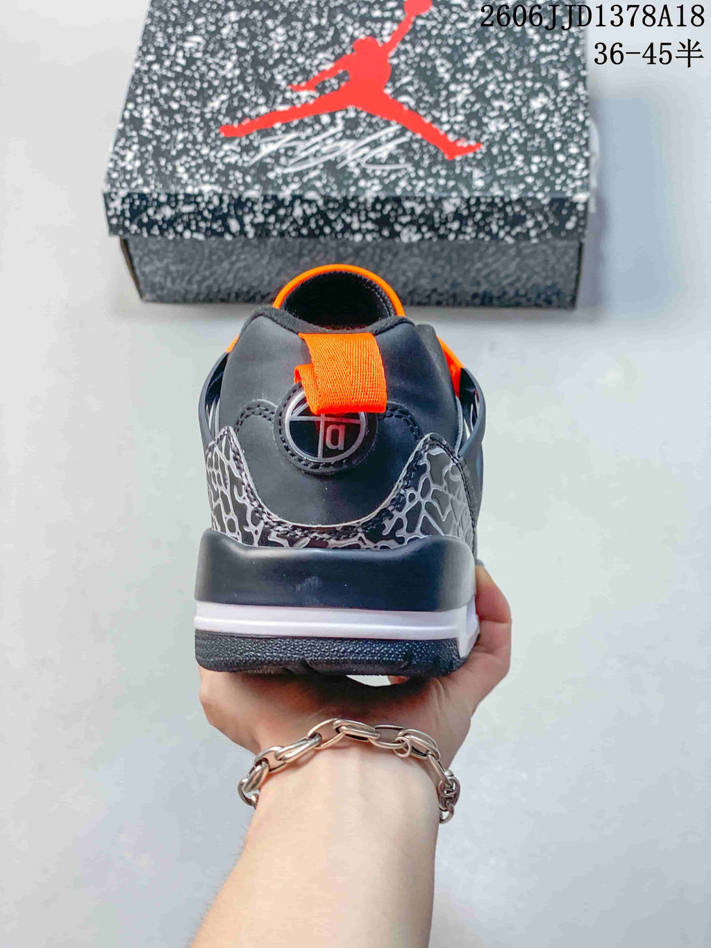 Rear view showing the orange pull tab and elephant-print heel panels.