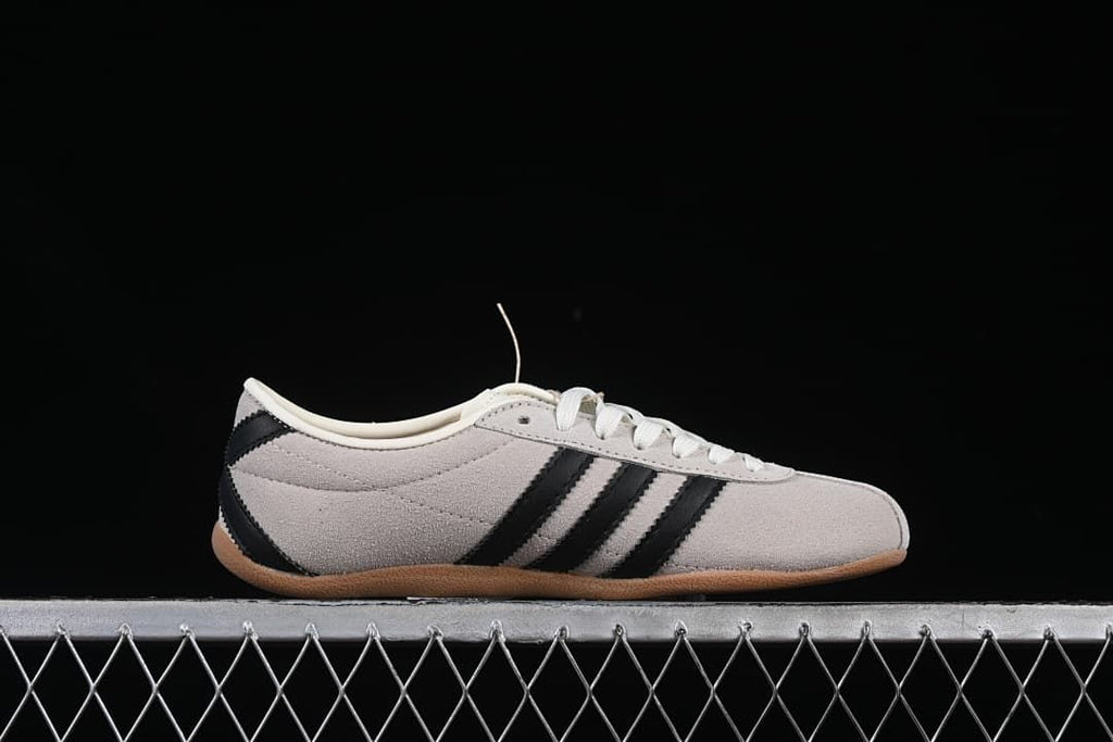 Side profile showing the low silhouette and three black stripes