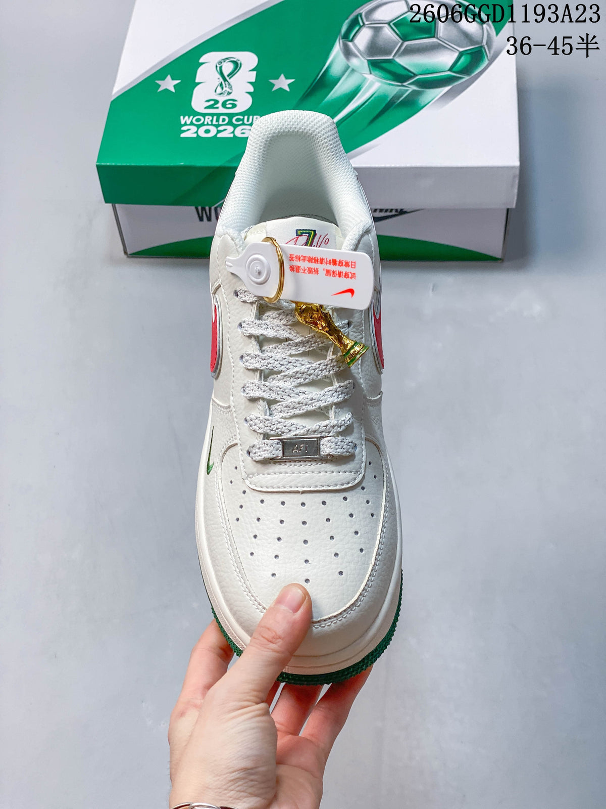 Front view showing perforated toe, laces and trophy-shaped charm