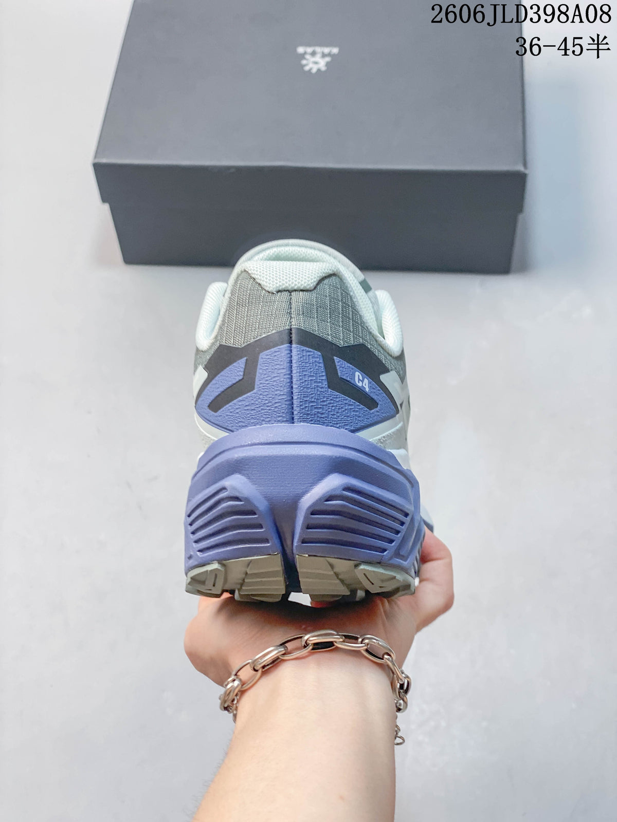 Rear view of the shoe showing the heel counter and lavender midsole