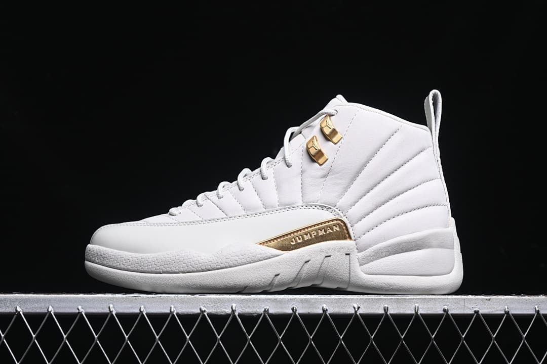 Side view of the white Air Jordan 12 Retro with gold-tone accents