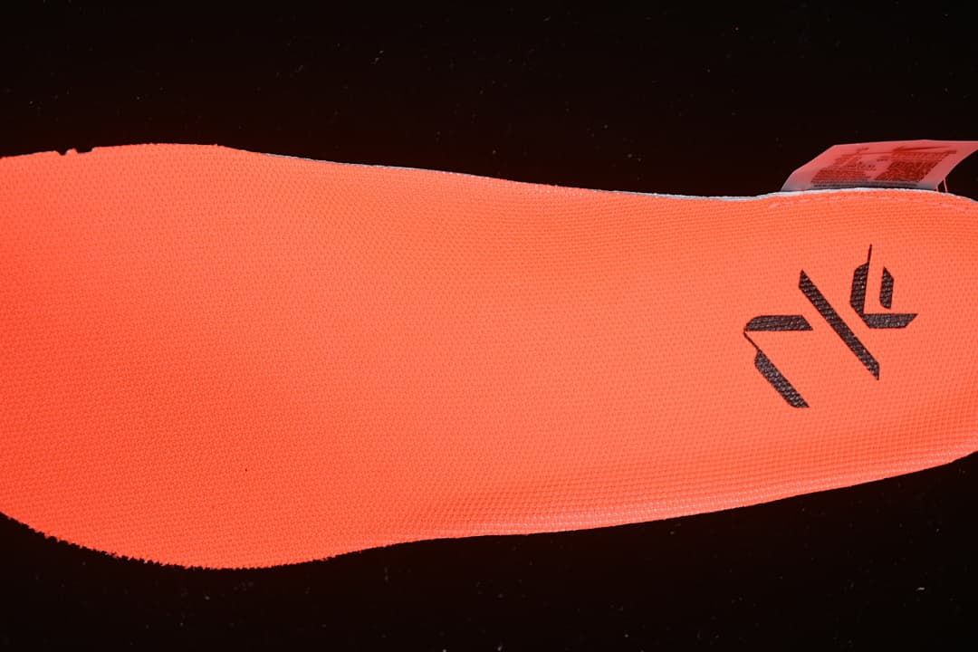 Close-up of the orange insole with a dark graphic