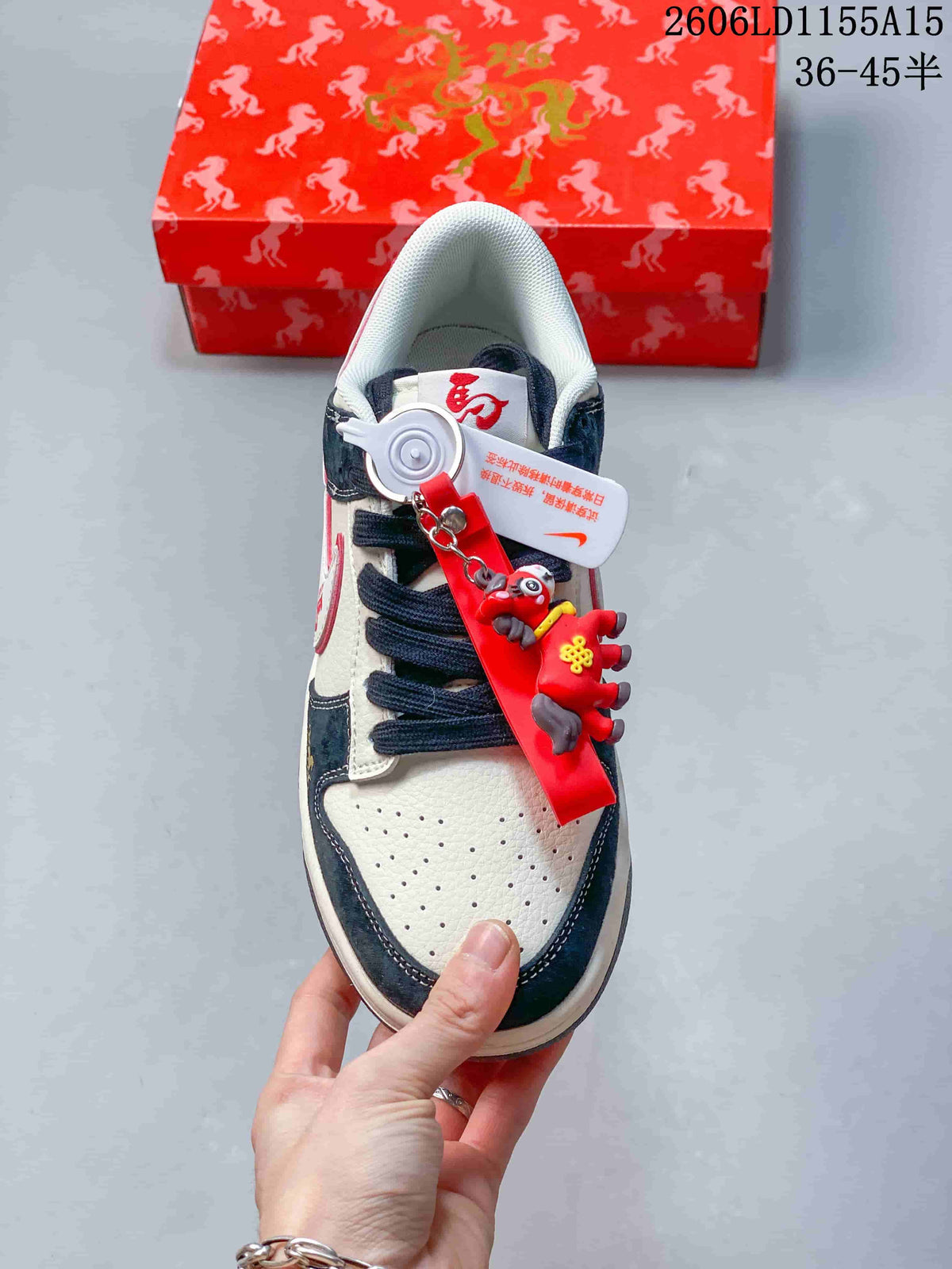 Top view showing perforated toe, dark laces and a red decorative charm