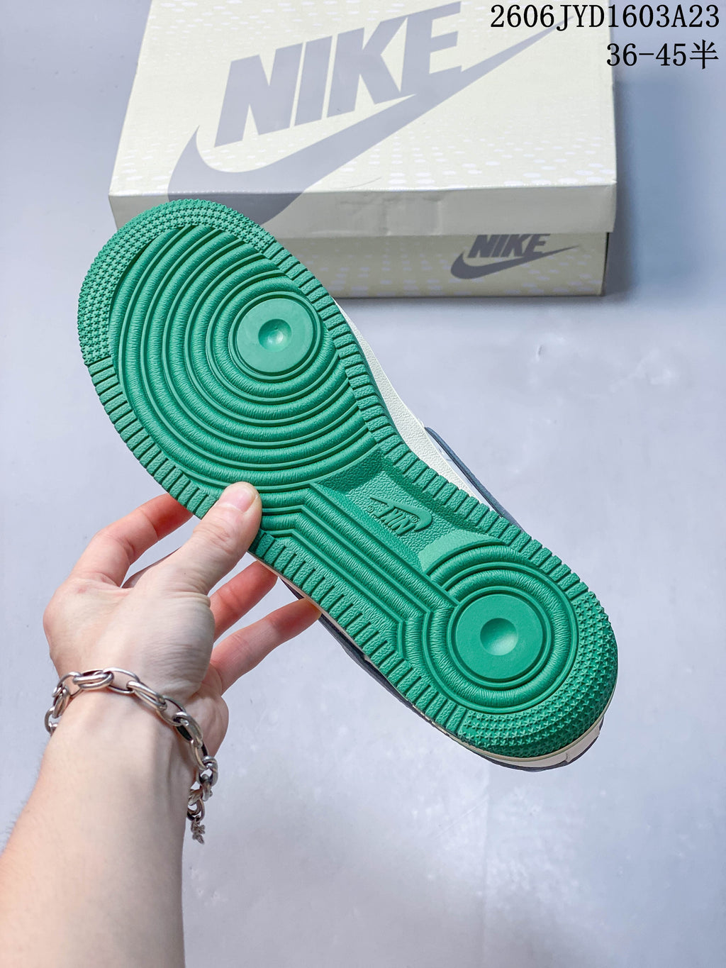 Close-up of the sneaker's green outsole and circular tread pattern.