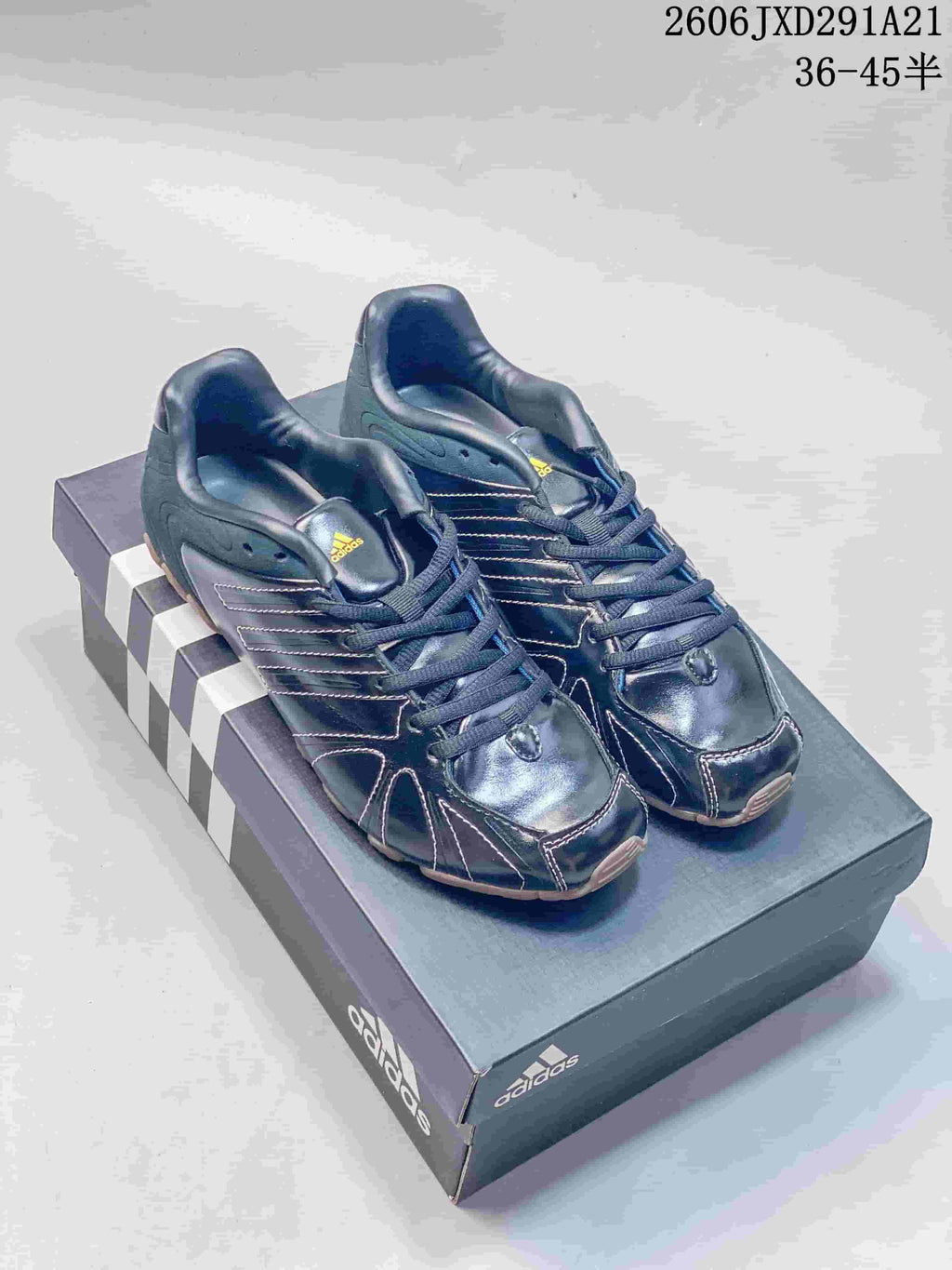Pair of dark navy Adidas Originals Ghost Sprint sneakers on a shoebox