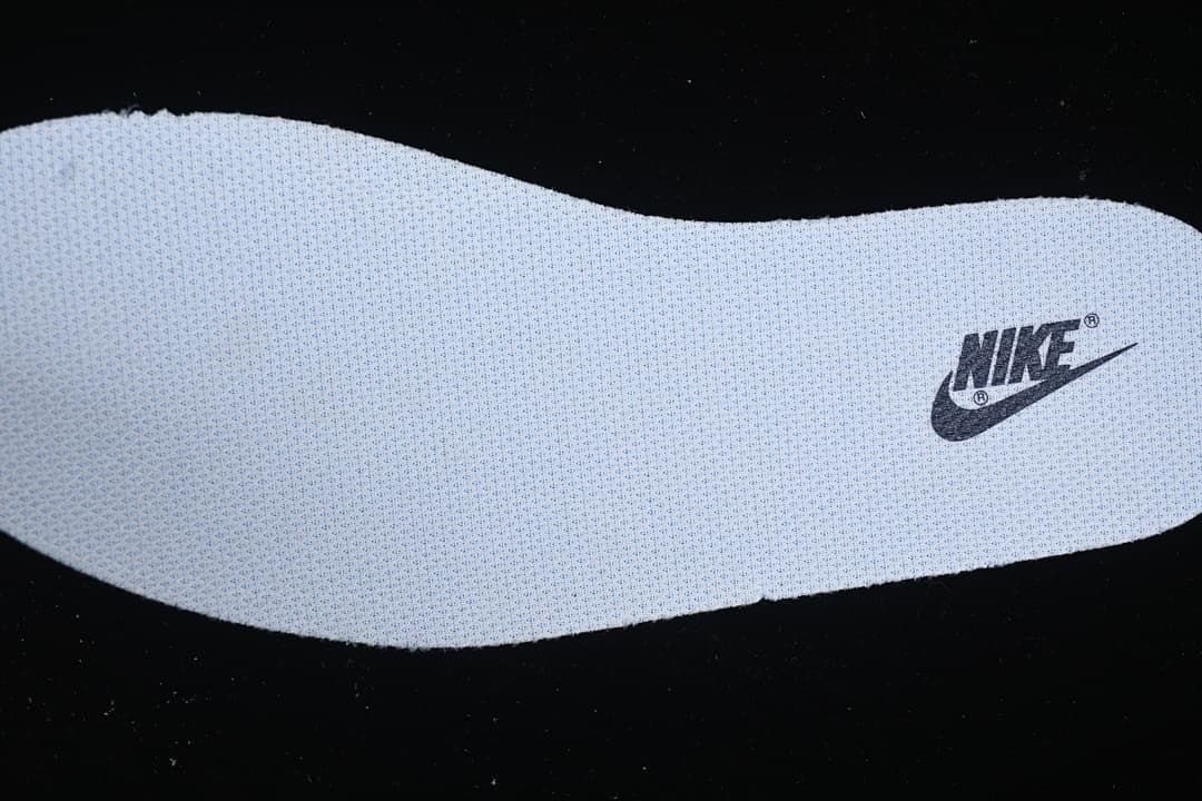 Close-up of a light-colored insole with Nike branding.