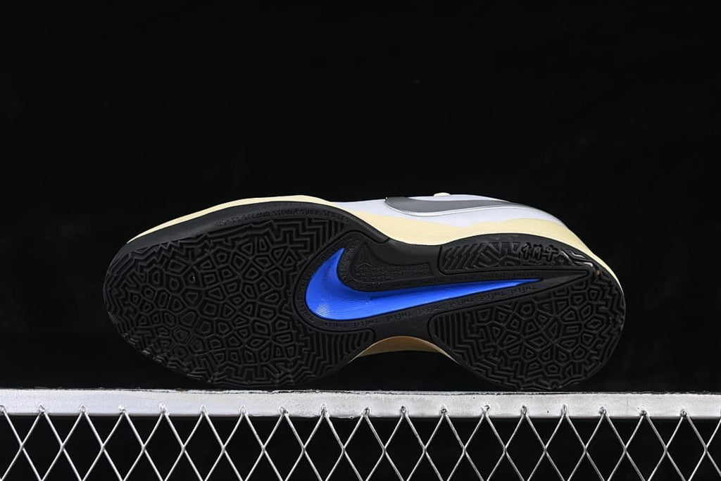 Underside view showing patterned black outsoles and blue accents
