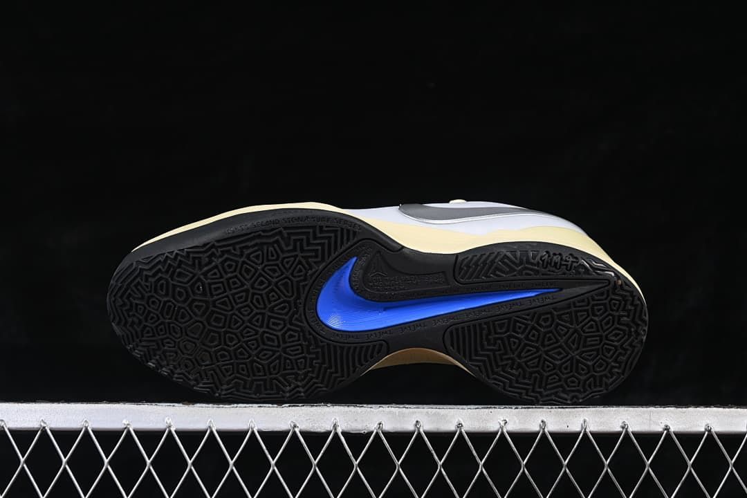 Underside view showing patterned black outsoles and blue accents