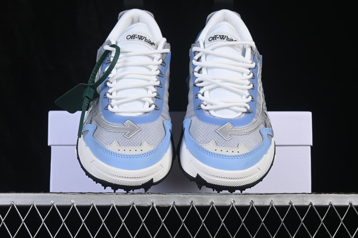 Front view of grey, white, and light-blue ODSY-2000 sneakers with arrow-shaped details