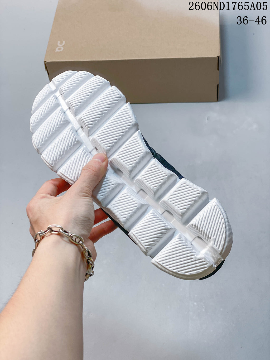 Close-up of the white segmented outsole on an On Cloud 5 sneaker