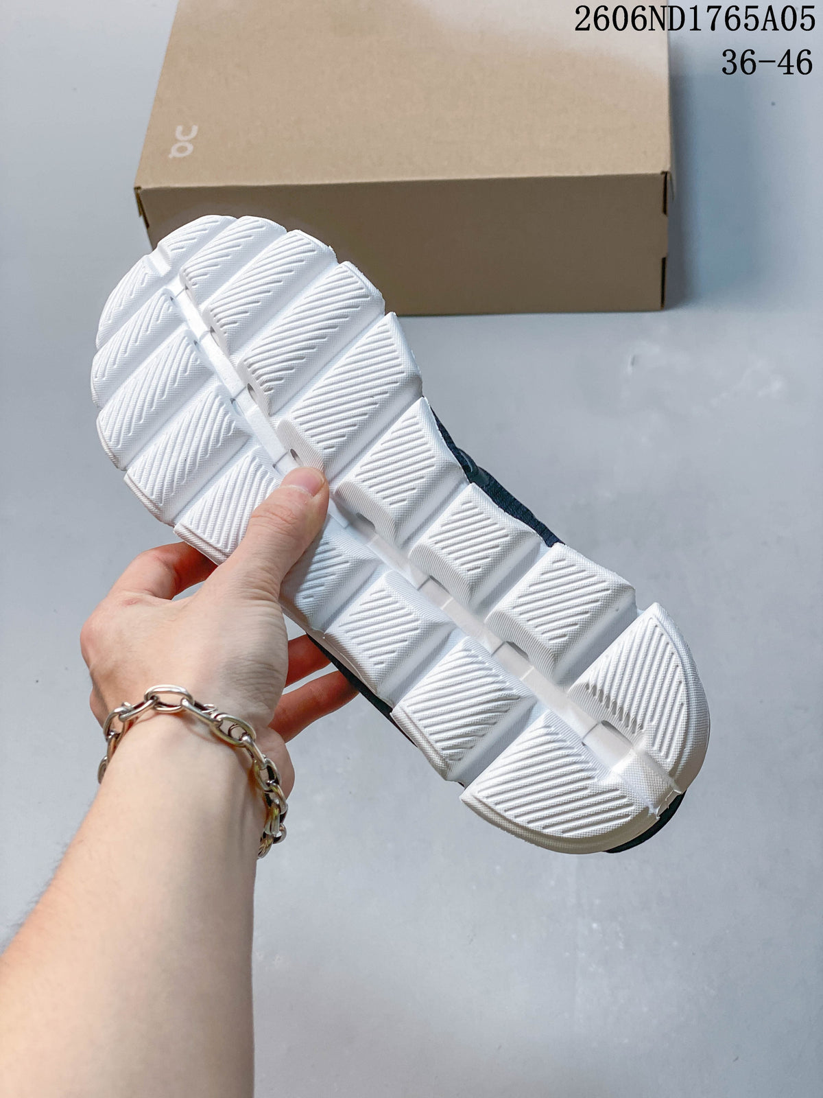 Close-up of the white segmented outsole on an On Cloud 5 sneaker