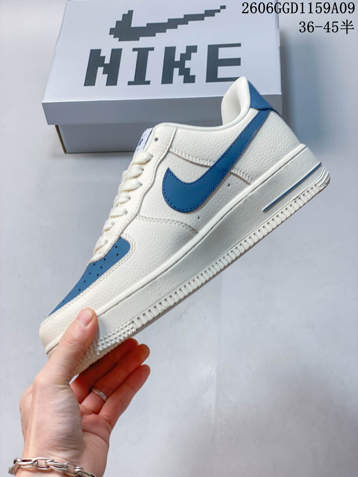 Side view of an off-white low-top sneaker with blue Swoosh and toe accents