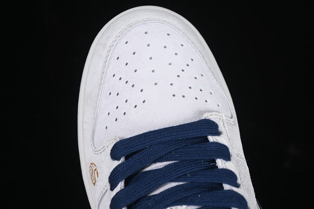 Top view of the perforated white toe and navy laces
