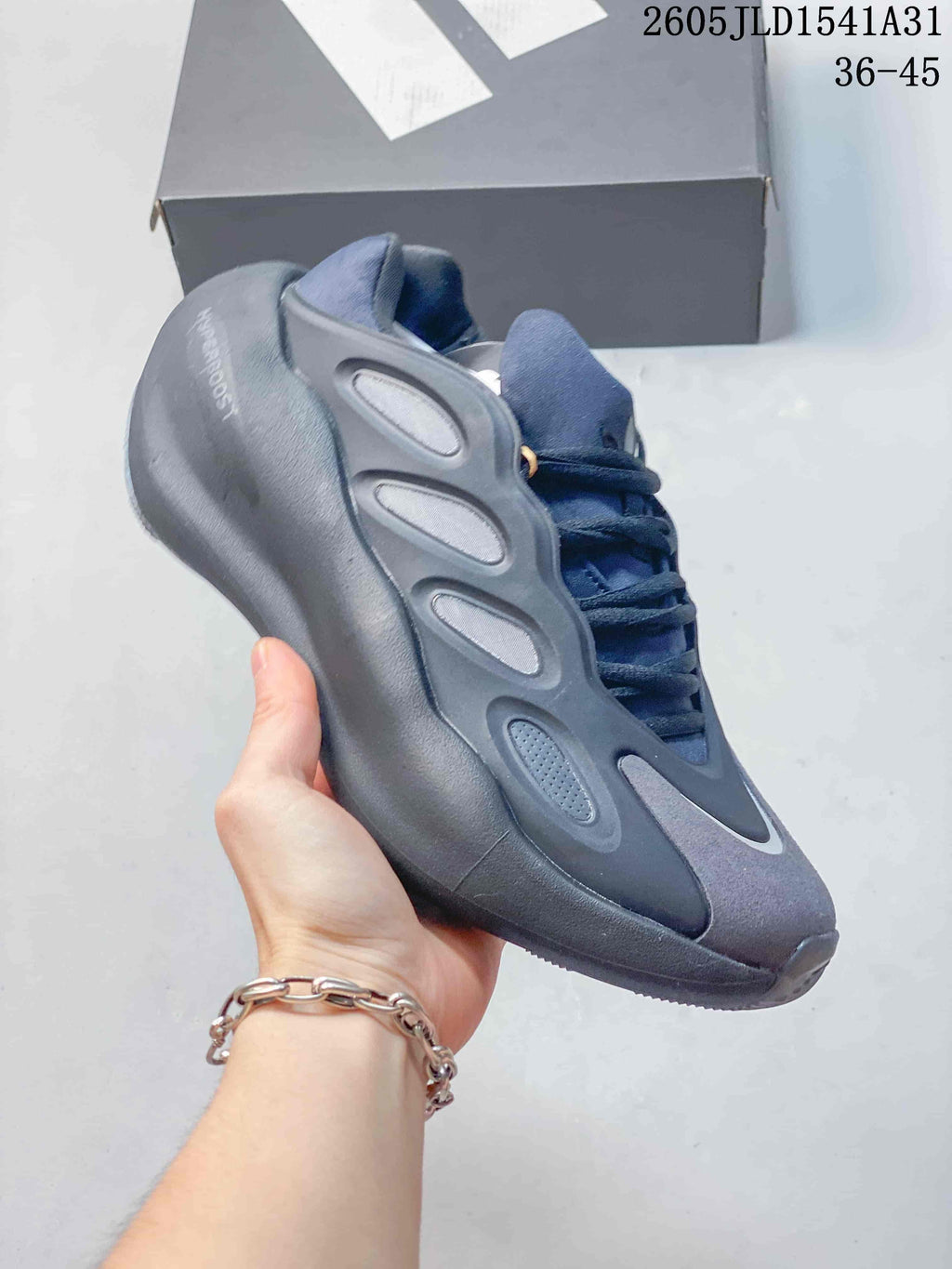 Angled side view of the Adidas Hyperboost sneaker and its sculpted side panels.