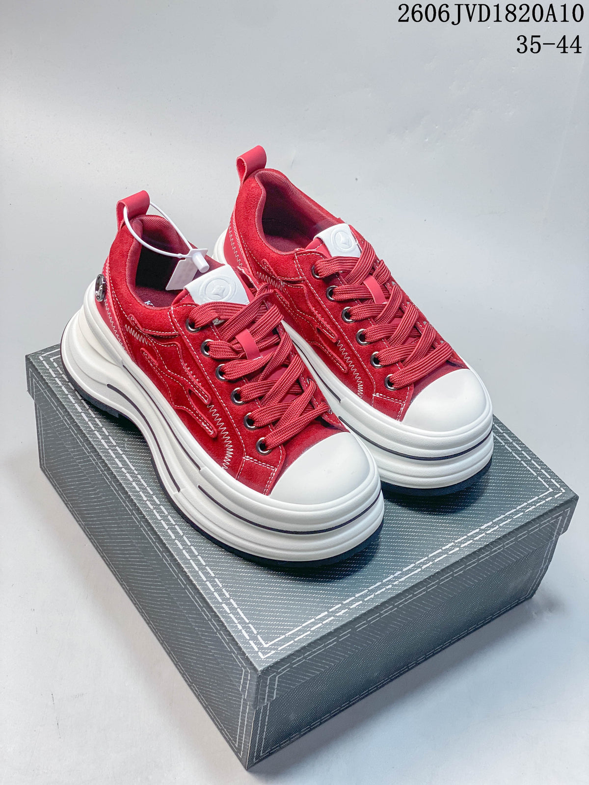 Pair of red KILLWINNER low-top sneakers with white toe caps and chunky platform soles