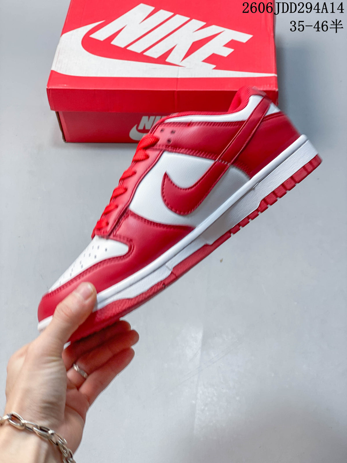 Side profile of a red and white Nike Dunk Low sneaker.