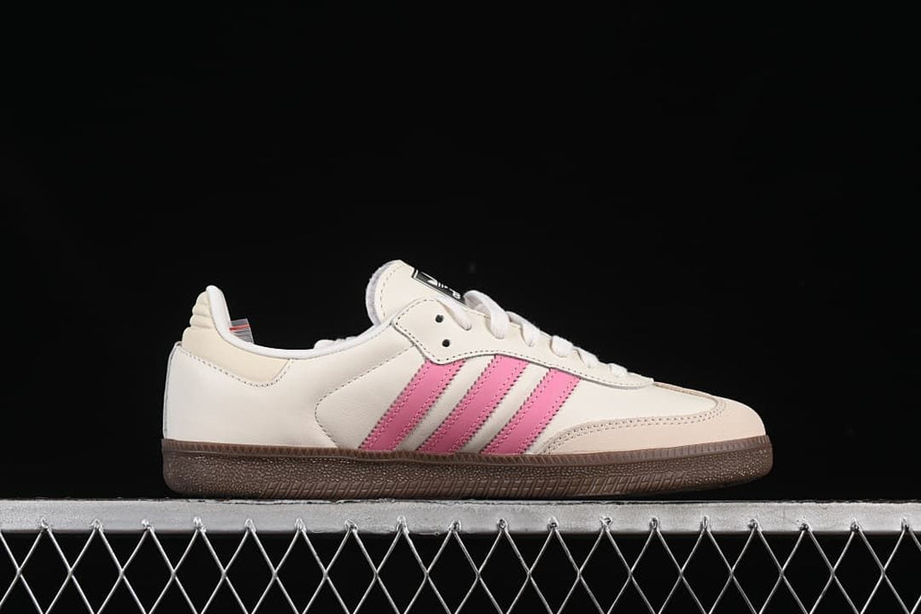 Side profile of an off-white Samba OG sneaker with pink stripes