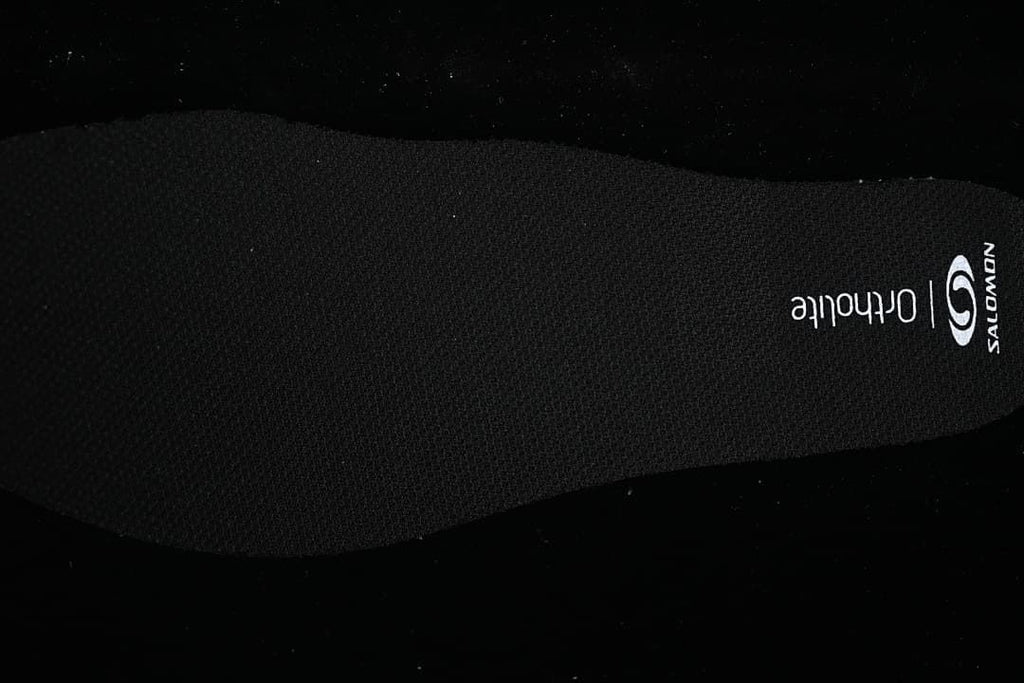 Black insole with Salomon and Ortholite markings