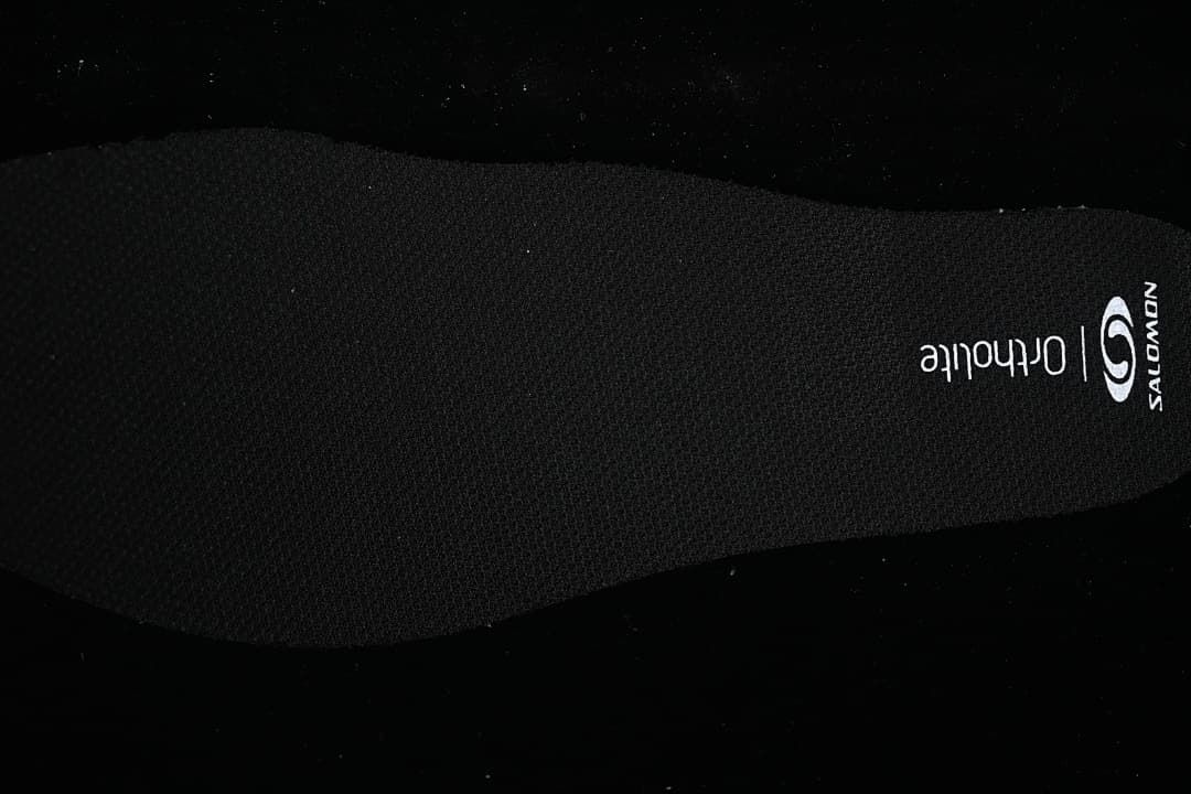 Black insole with Salomon and Ortholite markings