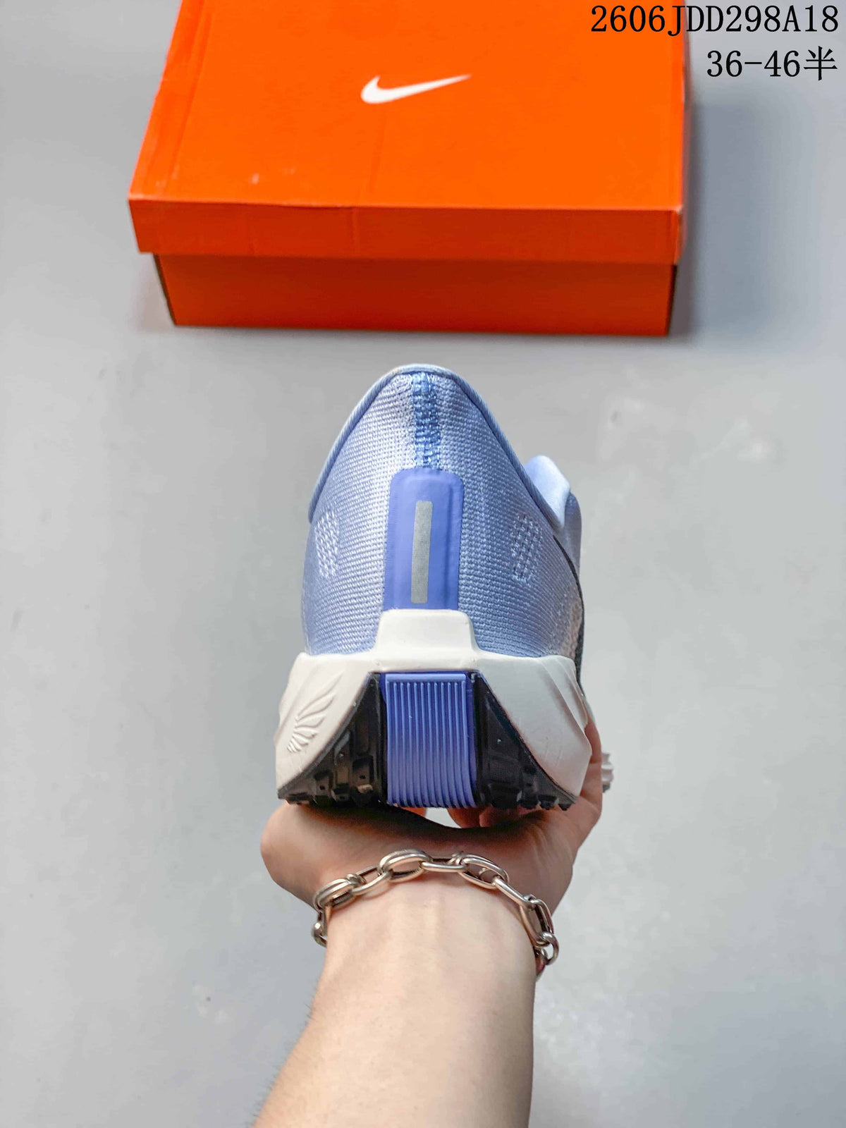 Rear view of the blue mesh heel and sculpted white midsole