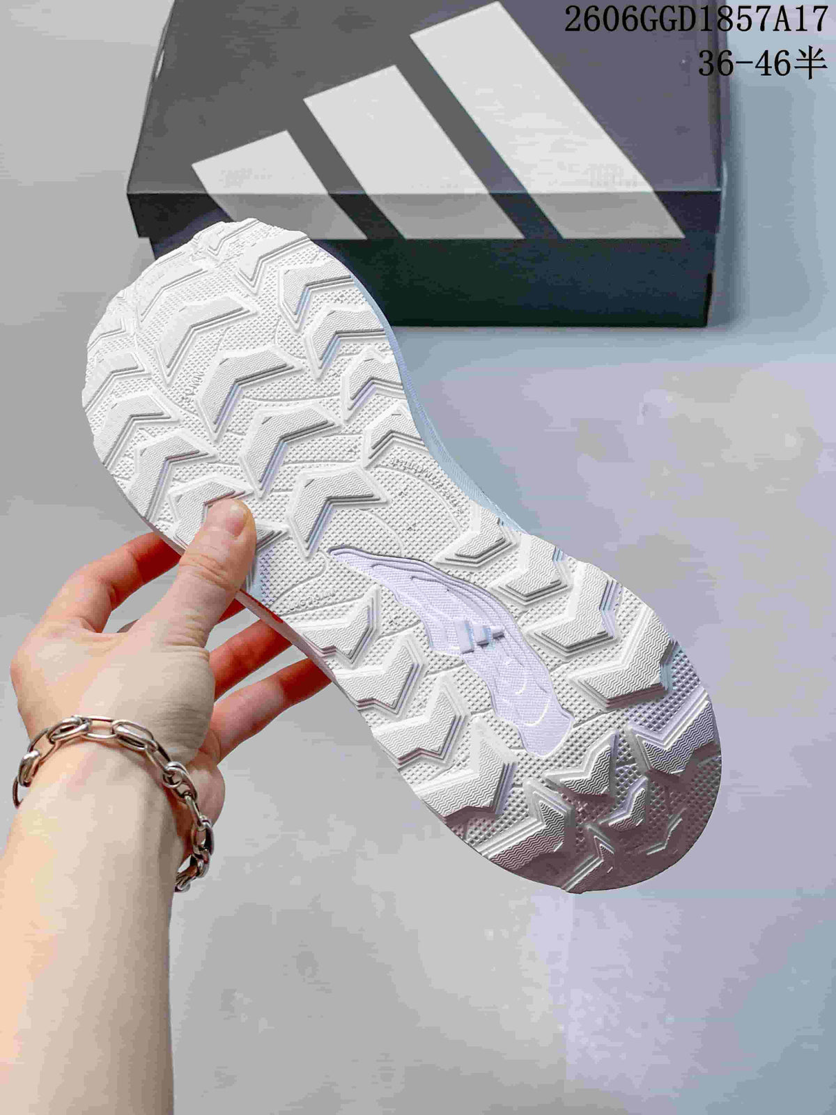 Close-up of the patterned outsole of a white Adidas shoe