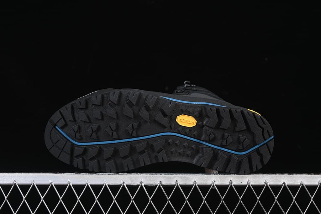Underside of the boot showing the lugged outsole and Vibram mark