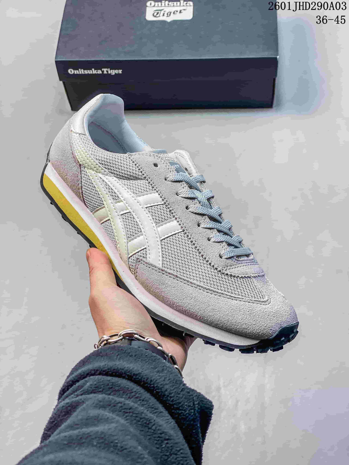 Gray mesh Onitsuka Tiger EDR 78 sneaker with white side stripes and a shoebox behind it.