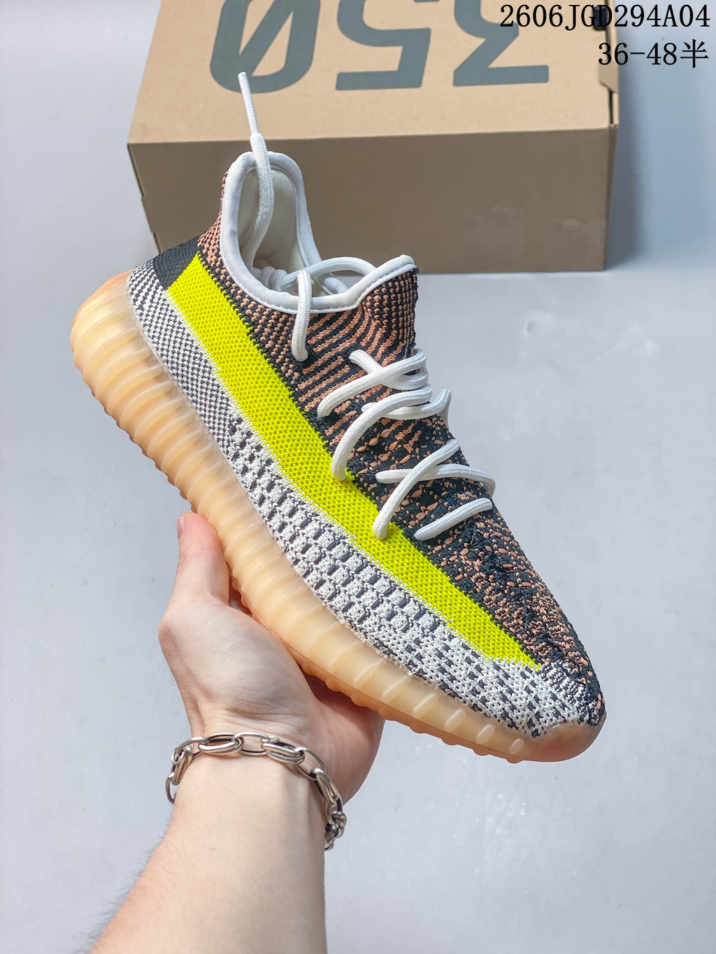 Side view showing the bright yellow stripe, patterned upper, and translucent amber-toned outsole