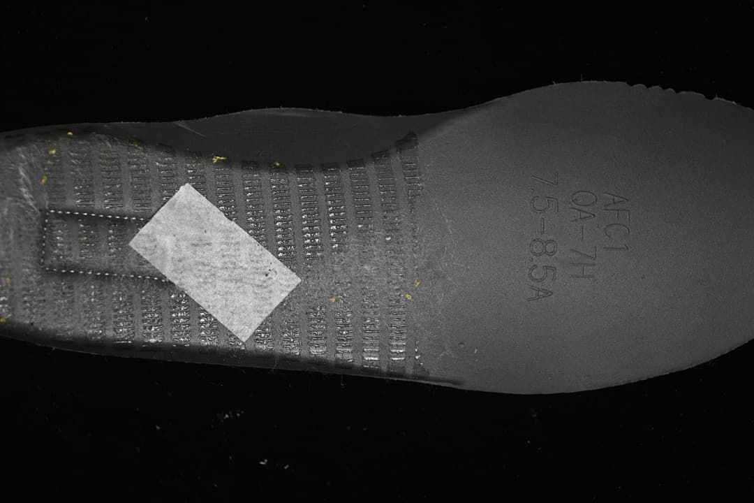 Close-up of the sneaker outsole with molded lettering and tread details.
