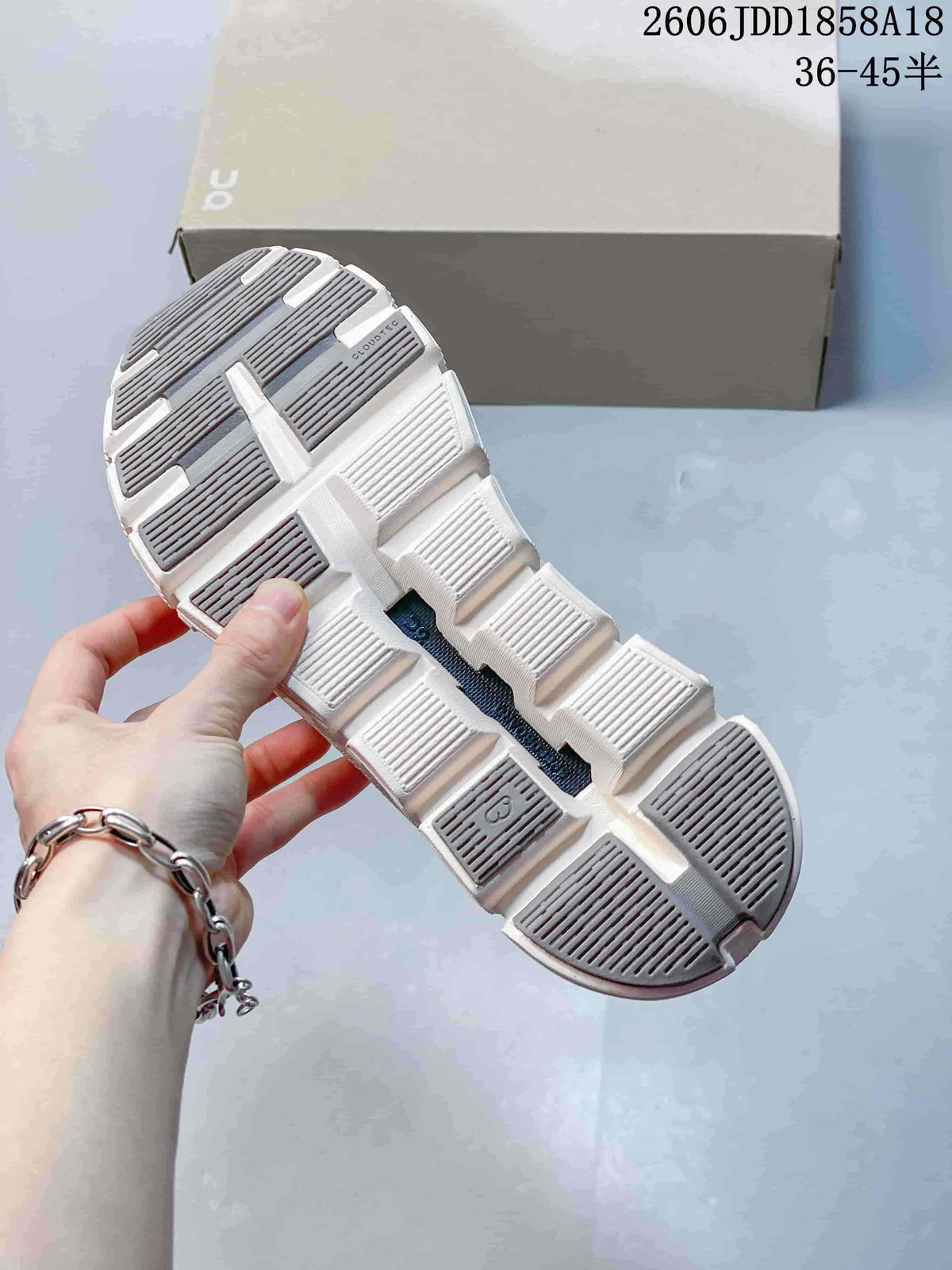 Close-up of the segmented outsole on an On Cloud 6 Coast sneaker
