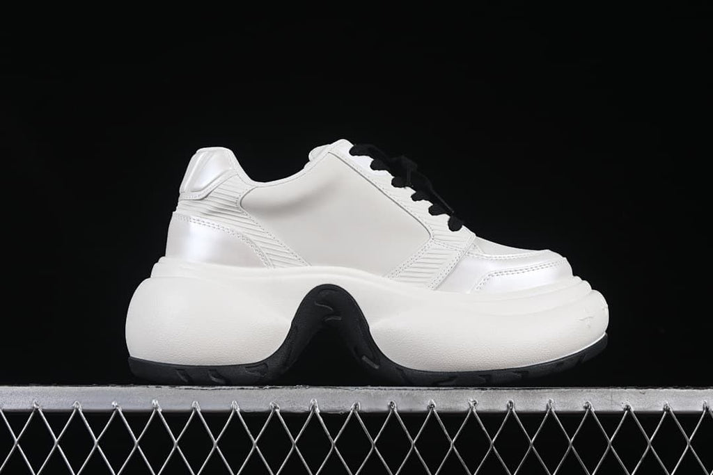 Side profile highlighting the thick sculpted sole and panel details