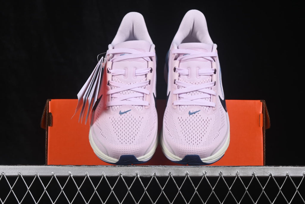 Front view of the pair positioned on an orange Nike shoe box.