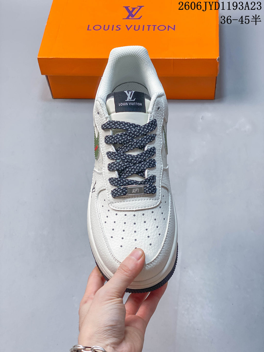 Front view showing the perforated toe, dark patterned laces, and white upper.