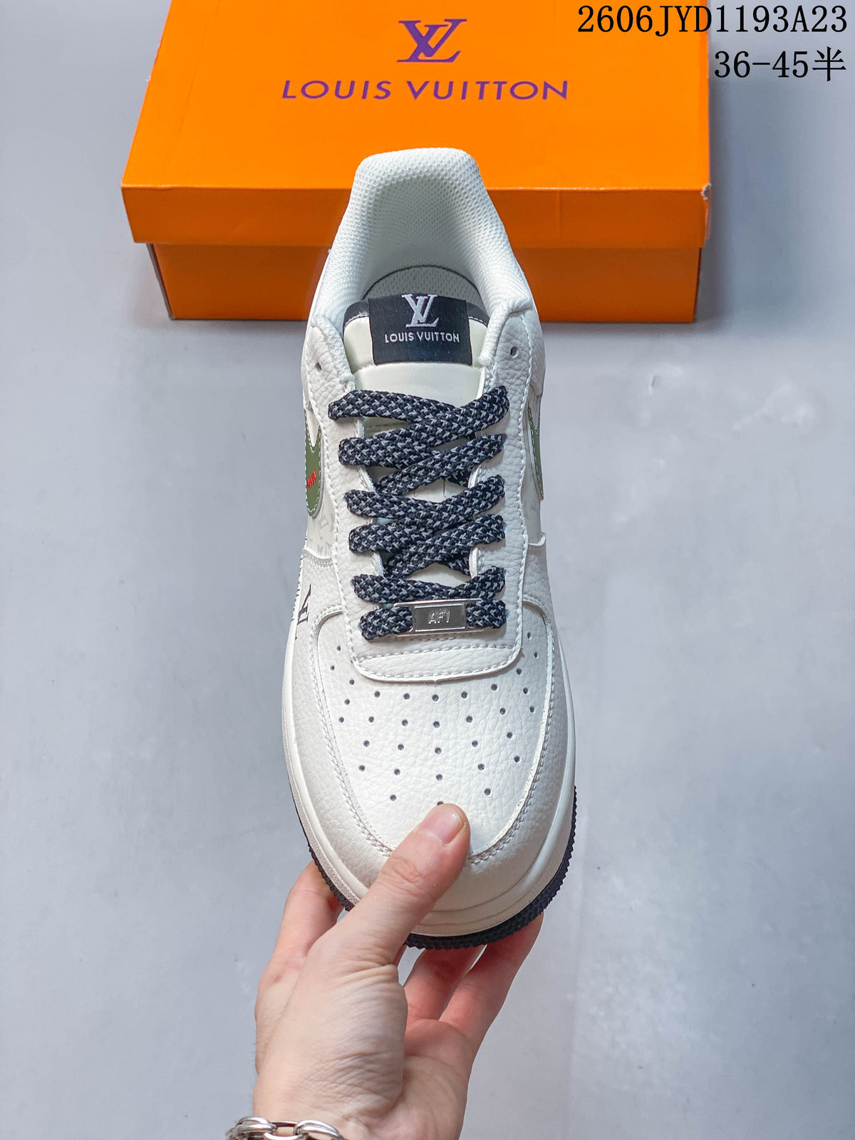 Front view showing the perforated toe, dark patterned laces, and white upper.