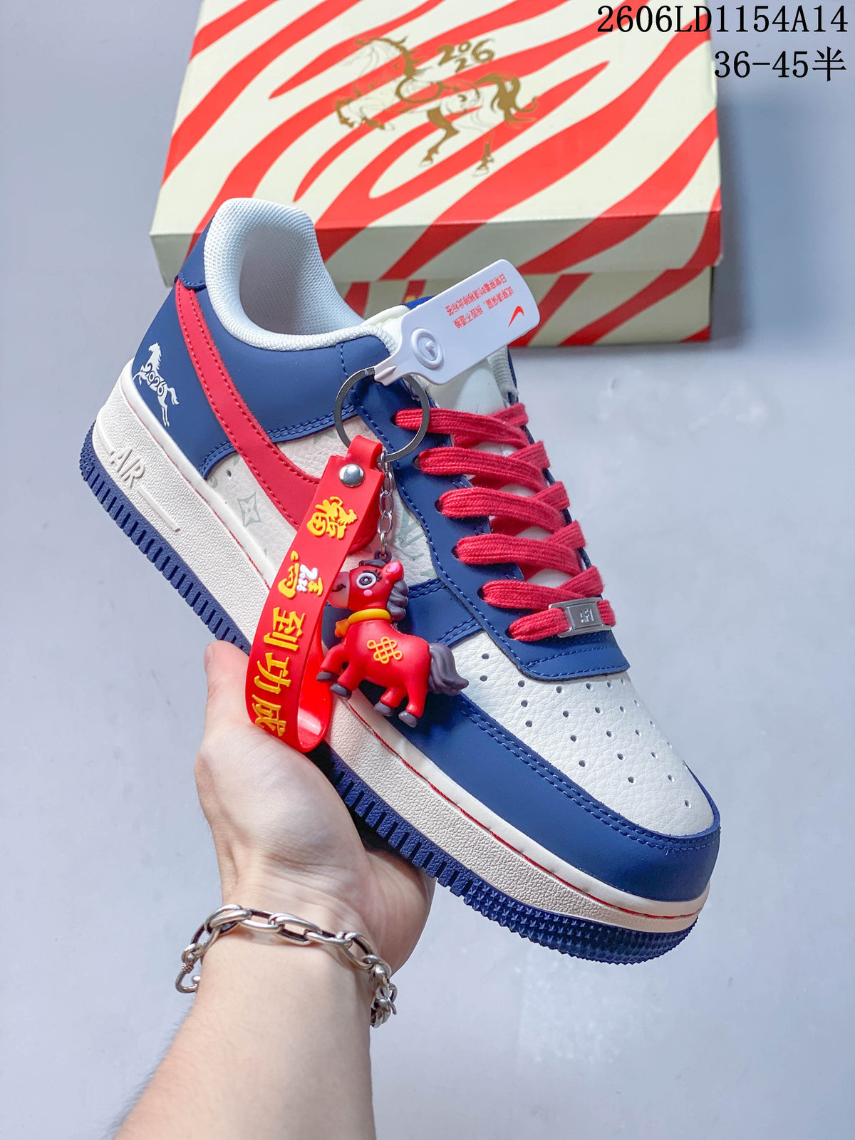 White and blue low-top sneaker with red laces, graphic detailing and a dangling red charm